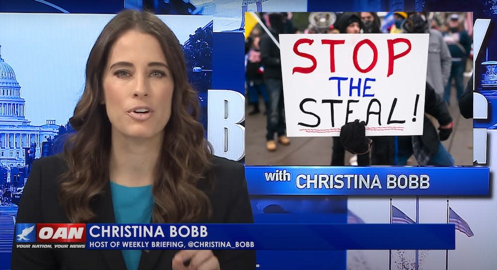 A still from OAN news in 2021, showing Christina Bobb, then an OAN anchor, alleging voter fraud in the 2020 election. She is seen speaking in front of a picture of a 'stop the steal' protest sign.