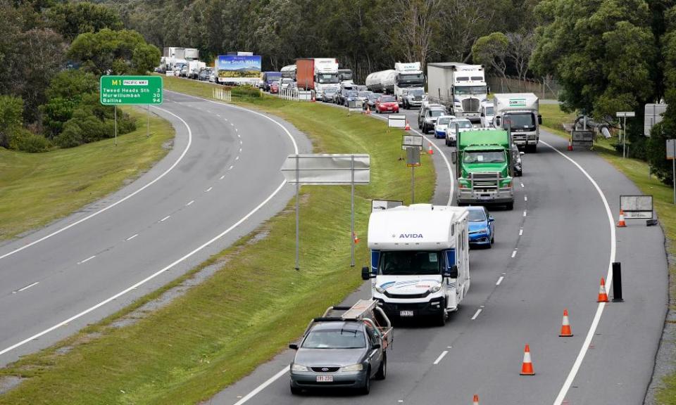 Motorists are seen approaching a checkpoint at Coolangatta on the Queensland/New South Wales border.