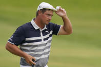 Bryson DeChambeau tips his cap after finishing on the 18th green during the final round of the U.S. Open Golf Championship, Sunday, June 20, 2021, at Torrey Pines Golf Course in San Diego. (AP Photo/Gregory Bull)