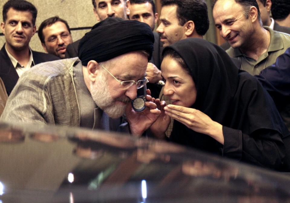 In this July 13, 2005, file photo, outgoing reformist Iranian President Mohammad Khatami talks on the phone with the mother of female journalist Masih Alinejad, right, after meeting with journalists in Tehran, Iran. (AP Photo/Hasan Sarbakhshian)