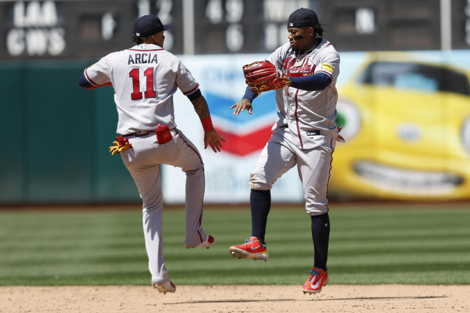 Atlanta Braves' Ronald Acuna Jr., right, and Orlando Arcia celebrate the team's win over the Oakland Athletics in a baseball game in Oakland, Calif., Thursday, May 31, 2023. (AP Photo/Jed Jacobsohn)
