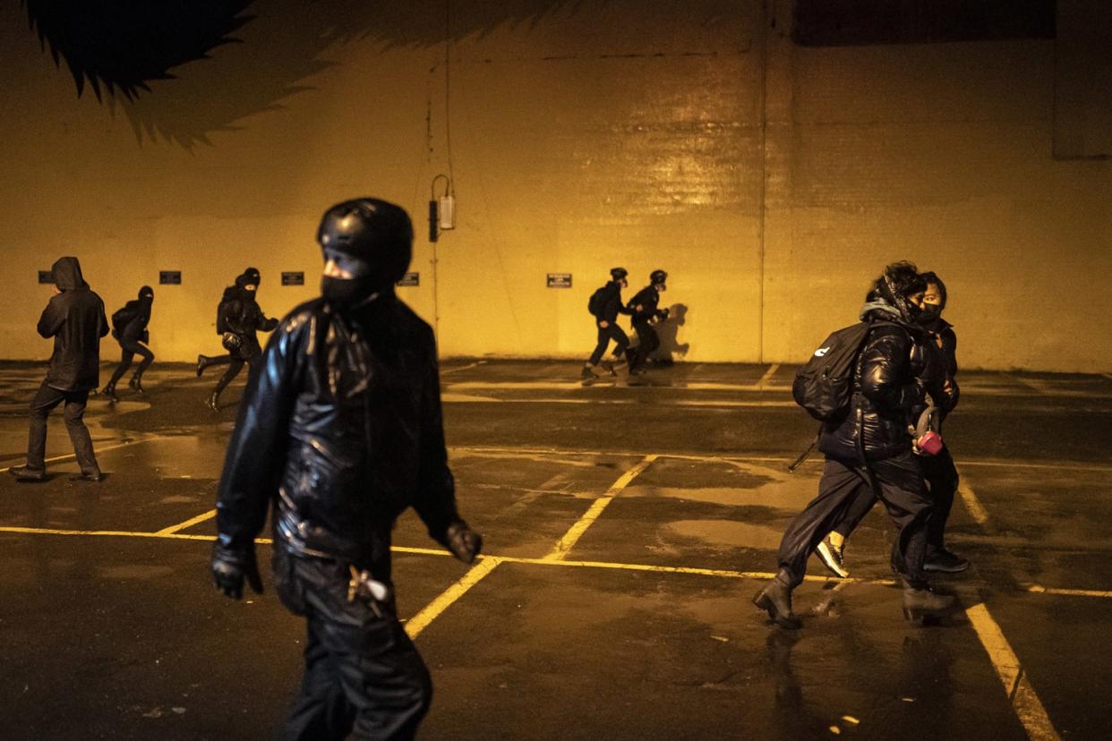 Image: Protesters flee from police during an Indigenous Peoples Day of Rage protest on Oct. 11, 2020 in Portland, Oregon. (Nathan Howard / Getty Images)