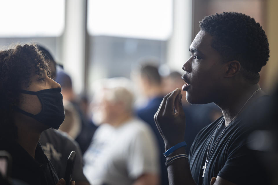 Patrick Lyoya supporters and supporters of Christopher Schurr confront one another in the hallway outside of Kent County District Court where Grand Rapids Police officer Schurr appeared on video from jail, Friday, June 10, 2022 in Grand Rapids, Mich. A judge facing a packed courtroom set bond Friday at $100,000 for Schurr, a Michigan police officer charged with second-degree murder in the death of Patrick Lyoya, a Black man who was shot in the back of the head in April. (Joel Bissell/The Grand Rapids Press via AP)