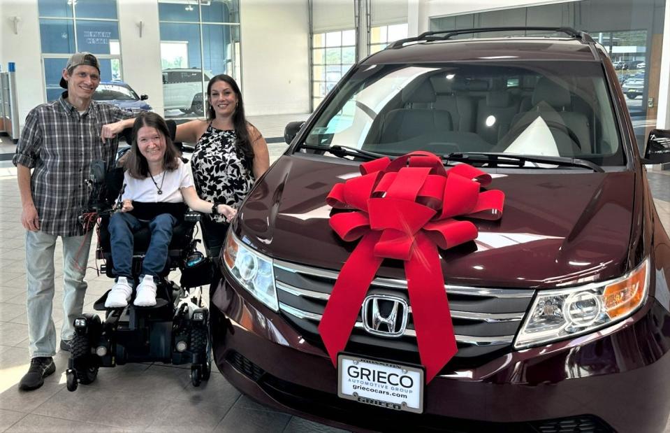Ray Muller and Lacie Messier, with daughter Ciarra Muller, pose next to the Honda Odyssey van gifted to their family by the Grieco Automotive Group.