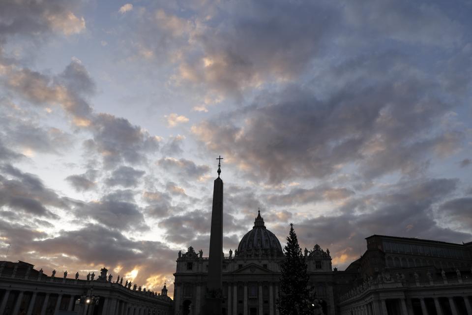 FILE - In this Thursday, Dec. 5, 2019 file photo, the sun sets over St. Peter's Basilica, at the Vatican. Vatican prosecutors have ordered the seizure of documents and computers from the administrative offices of St. Peter’s Basilica in an apparently new investigation into financial irregularities in the Holy See. The Vatican said Tuesday that Pope Francis has also named a special commissioner to run the basilica, reorganize its offices, update its statutes to comply with new Vatican norms on procurement contracts and to “clarify its administration.” (AP Photo/Gregorio Borgia, File)