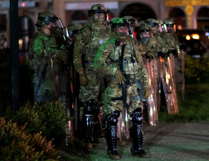 FILE PHOTO: National Guard soldiers prepare to clear Jefferson Square park where demonstrators have assembled, during a protest after a grand jury decided not to bring homicide charges against police officers involved in the fatal shooting of Breonna Taylo