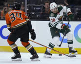 Minnesota Wild right wing Ryan Hartman (38) shoots the puck past Anaheim Ducks defenseman Jamie Drysdale (34) during the first period of an NHL hockey game Friday, Oct. 15, 2021, in Anaheim, Calif. (AP Photo/John McCoy)