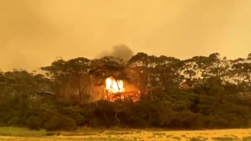A view of an explosion after bushfires caused a house to go up in flames in Rosedale