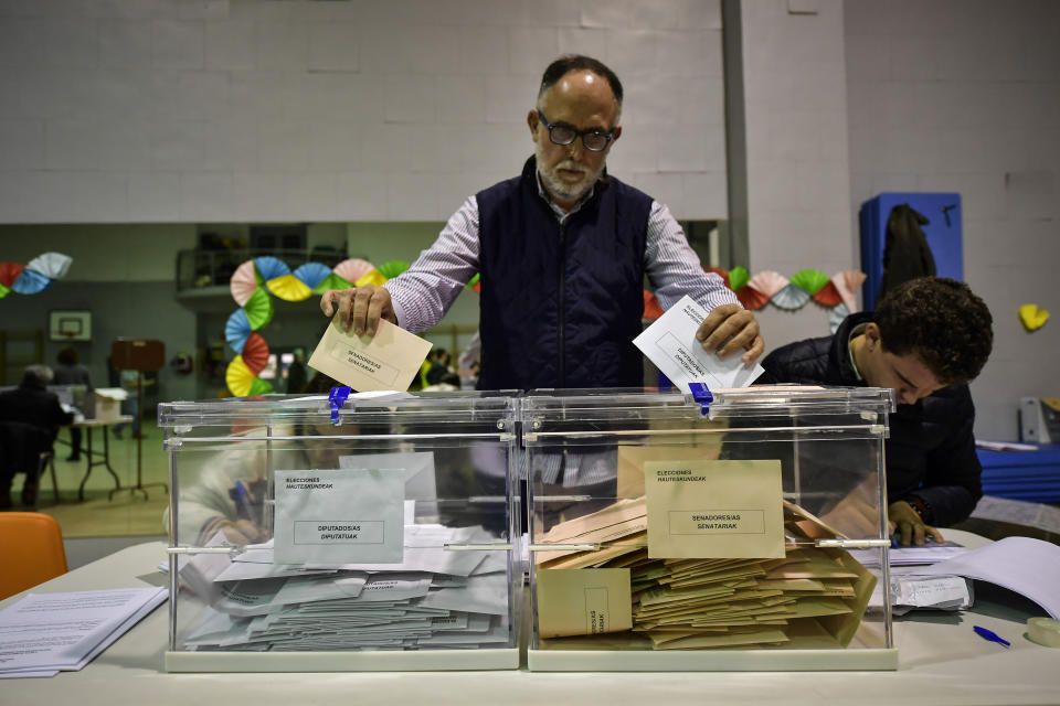 A member of a polling station sorts the postal votes, during the general election in Pamplona, northern Spain, Sunday, Nov. 10, 2019. As Spaniards voted Sunday in the country’s fourth election in as many years, a leading leftist party pledged to help the incumbent Socialists in hopes of staving off a possible right-wing coalition government that could include a far-right party. (AP Photo/Alvaro Barrientos)