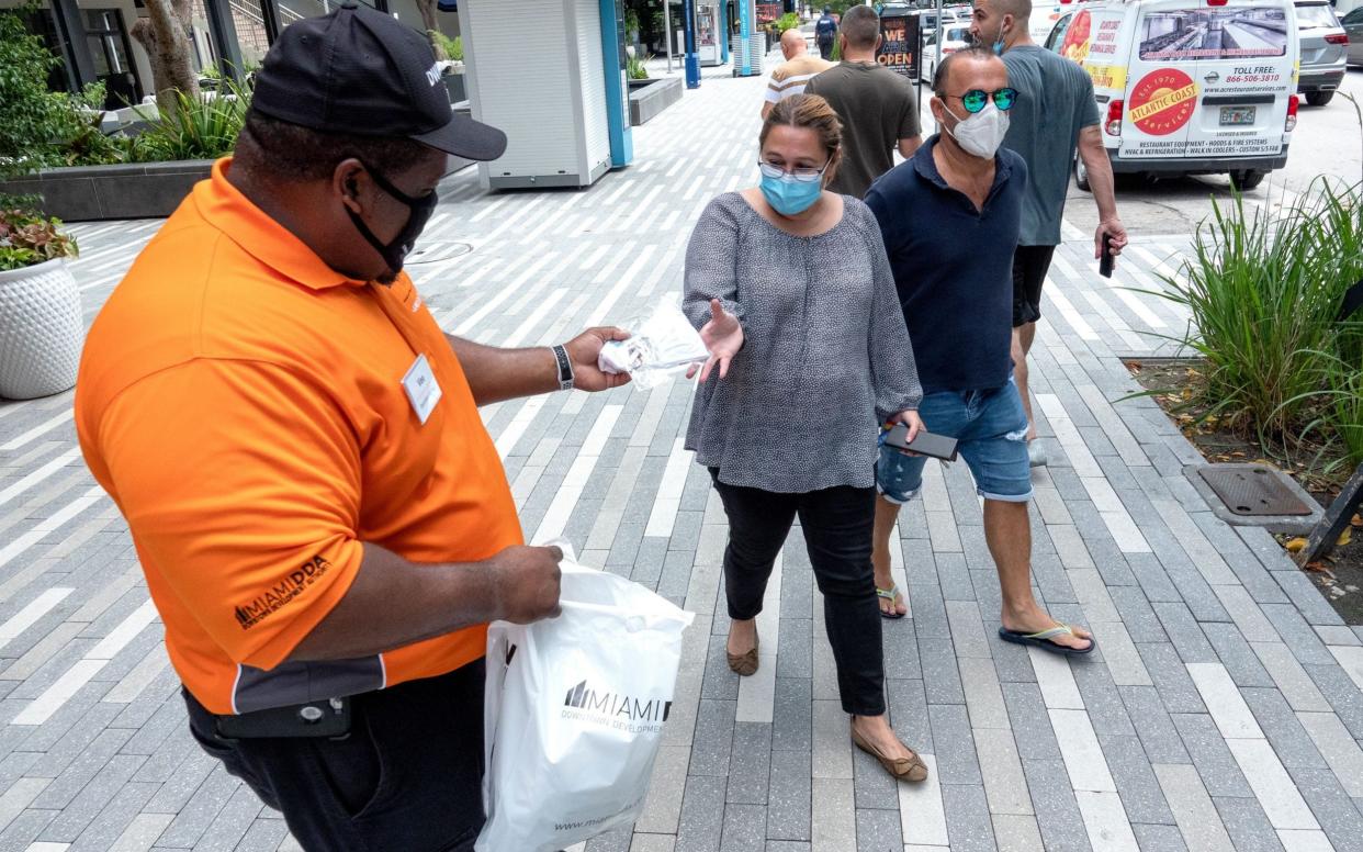 Free face masks are distributed in Downtown Miami, Florida - CRISTOBAL HERRERA-ULASHKEVICH/EPA-EFE/Shutterstock