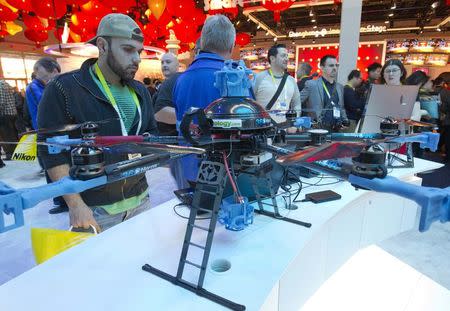 A man looks over a 360Heros drone at the Intel booth during the 2015 International Consumer Electronics Show (CES) in Las Vegas, Nevada, in this file photo taken January 6, 2015. REUTERS/Steve Marcus/Files