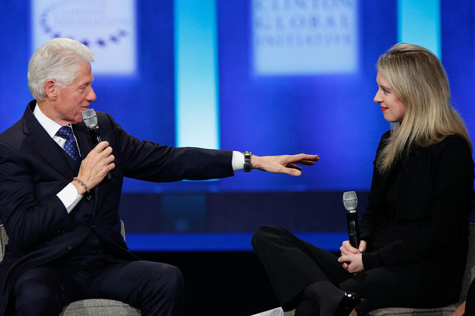 U.S. President Bill Clinton speaks as Elizabeth Holmes, founder and CEO of Theranos listens during the closing session of the Clinton Global Initiative 2015 on Sept. 29, 2015 in New York City.<span class="copyright">JP Yim—Getty Images</span>