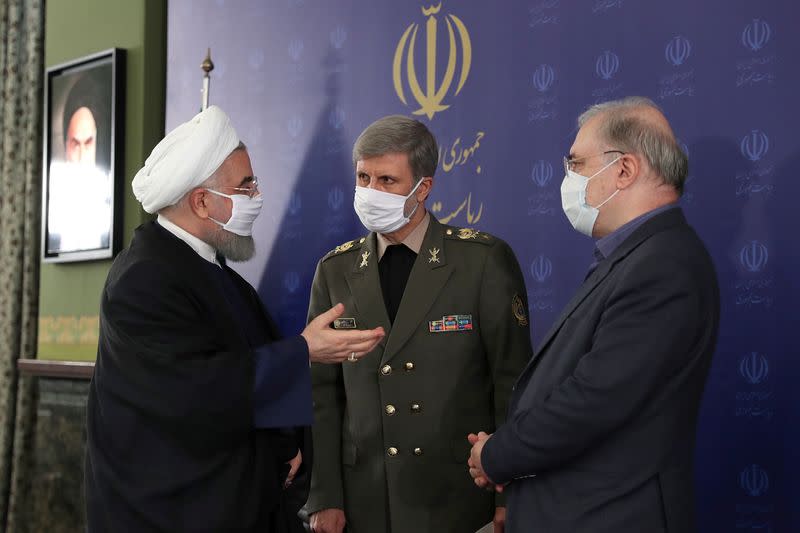 Iranian President Hassan Rouhani and Iranian Defense Minister Brigadier General Amir Hatami, wearing face masks during a meeting, in Tehran