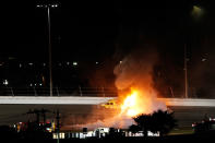 DAYTONA BEACH, FL - FEBRUARY 27: Safety workers try to extinguish a fire from a jet dryer after being hit by Juan Pablo Montoya, driver of the #42 Target Chevrolet, under caution during the NASCAR Sprint Cup Series Daytona 500 at Daytona International Speedway on February 27, 2012 in Daytona Beach, Florida. (Photo by Streeter Lecka/Getty Images)