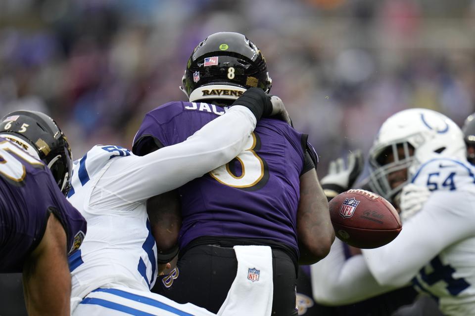Baltimore Ravens quarterback Lamar Jackson (8) fumbles as he is hit by Indianapolis Colts' Samson Ebukam (52) during the first half of an NFL football game, Sunday, Sept. 24, 2023, in Baltimore. (AP Photo/Julio Cortez)