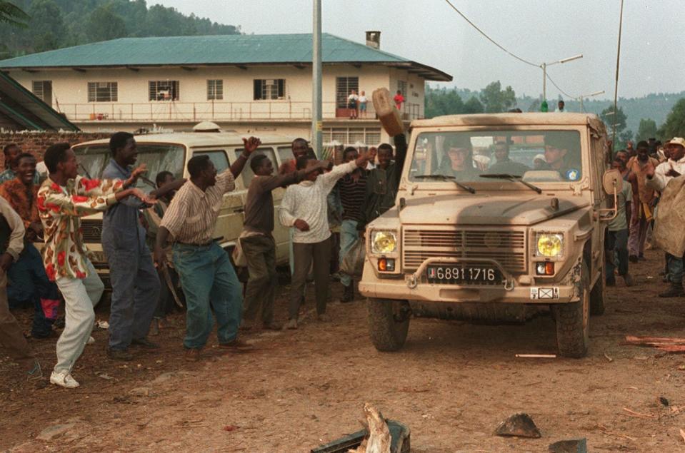 FILE - In this August 21, 1994 file photo, Rwandan Hutus give the departing French troops the thumbs-up as the French army pull out of Cyangugu, in southwest Rwanda. A report commissioned by the Rwandan government due to be made public on Monday, April 19, 2021 concludes that the French government bears "significant" responsibility for "enabling a foreseeable genocide" that left more than 800,000 dead in 1994 and that that France "did nothing to stop" the massacres. (AP Photo/Jean Marc Bouju, File)