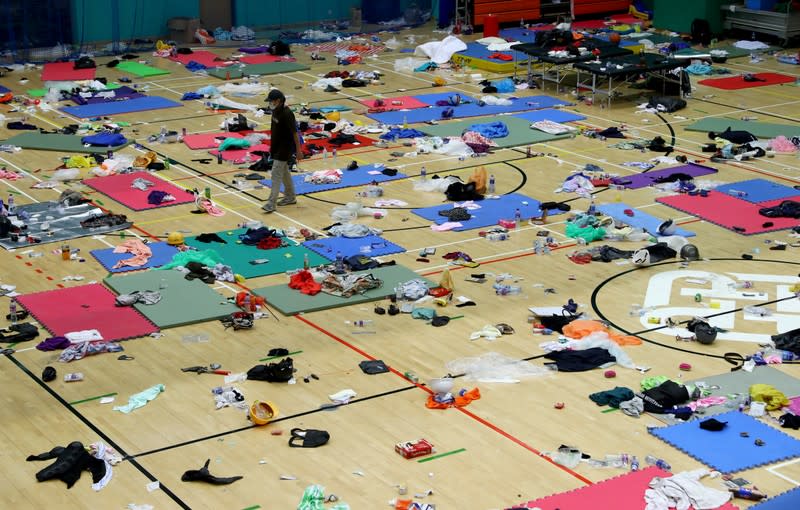 A protester walks in the gymnasium which served as a sleeping area on the campus of the Hong Kong Polytechnic University