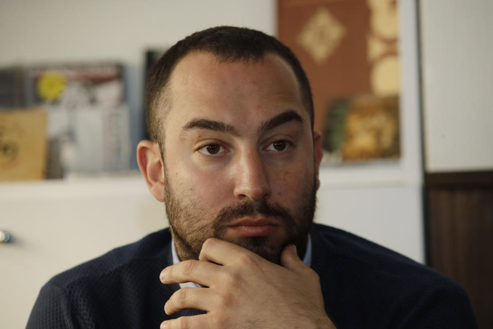 Francesco Polacchi, regional coordinator of Casapound extreme right political party, and founder of Altaforte publishing company, answers to reporters during a news conference, in Milan, Italy, Wednesday, May 8, 2019. Holocaust survivor, poet Halina Birenbaum, is set to open a book fair in Turin after the organizers agreed to demands that she and the Auschwitz-Birkenau state museum made to remove the stand of Altaforte publishing company. (AP Photo/Luca Bruno)