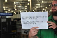 <p>An employee holds a sign showing water has sold out in a chained market in Houston, Texas on Aug. 24, 2017. (Photo: Liu Liwei/Xinhua via ZUMA Wire) </p>