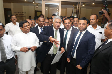 Sri Lanka's ousted Prime Minister Ranil Wickremesinghe gestures with party members inside the parliament at a news conference in Colombo, Sri Lanka November 14, 2018. REUTERS/Stringer