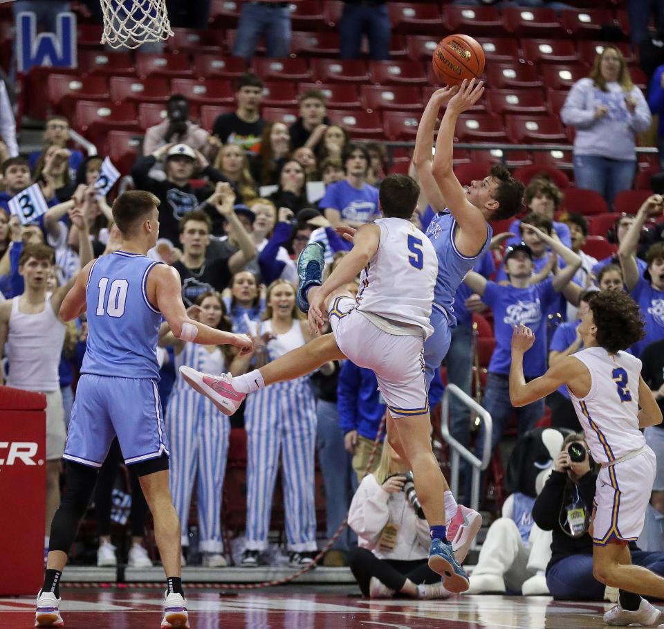 Mineral Point High School’s Drew Ashliman (21) scores a basket on a putback against Kenosha St. Joseph Catholic Academy in the Division 4 state championship game during the WIAA state boys basketball tournament on Saturday, March 16, 2024 at the Kohl Center in Madison, Wis. Mineral Point won the game, 65-64, on a putback basket with 1.4 seconds remaining in the game.