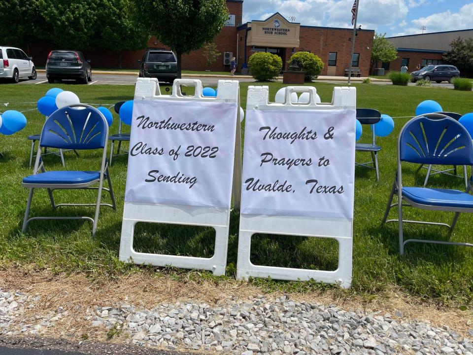 Seniors at Northwestern High School in West Salem created signs to accompany 21 seats representing those who died in the Uvalde, Texas, school shooting. The signs and chairs were visible during graduation on Sunday.