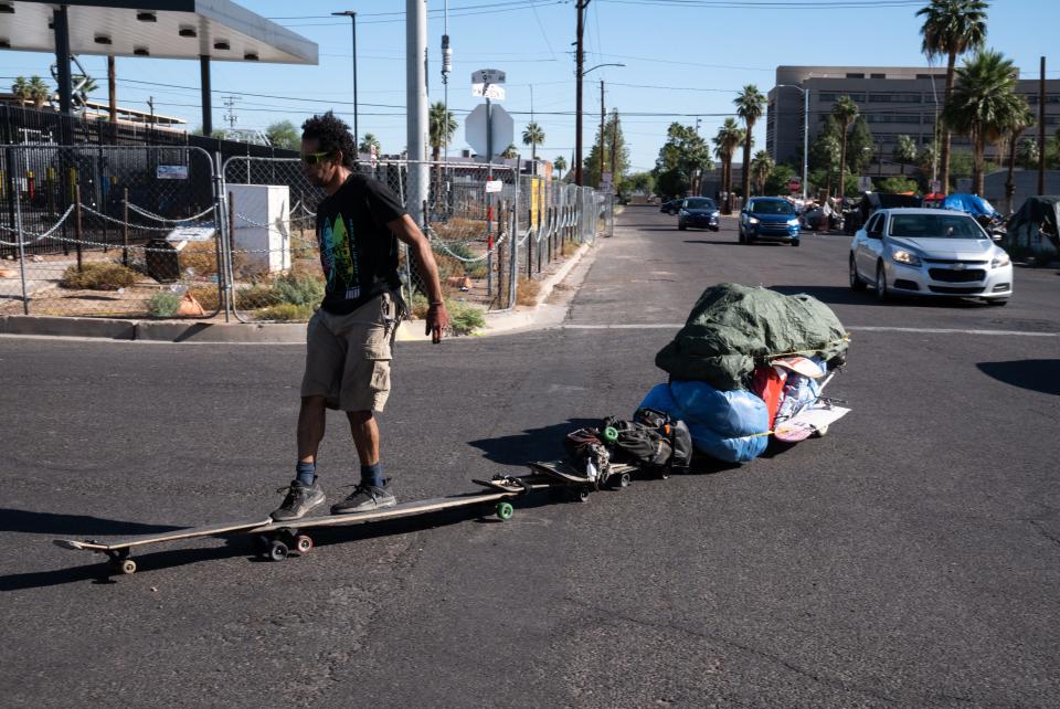 Joel Gonzalez (front) and his partner, Laura Settergren, moved from 12th Avenue to the corner of Ninth Avenue on May 31, 2023, after Phoenix cleared the second block of "The Zone" homeless encampment.