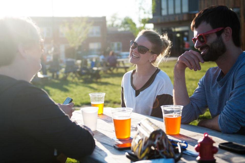 Janelle Schultz enjoys a beer outside at Logboat Brewing Co. in 2015.