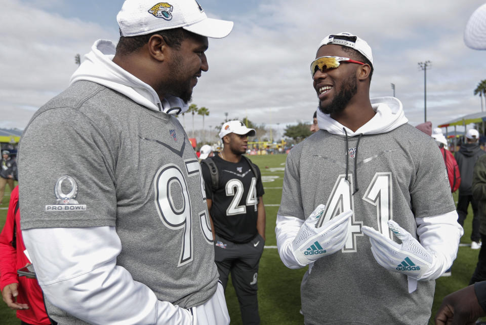 AFC defensive ends Calais Campbell, left, and Josh Allen, both of the Jacksonville Jaguars, talk during a practice for the NFL Pro Bowl football game Wednesday, Jan. 22, 2020, in Kissimmee, Fla. (AP Photo/John Raoux)