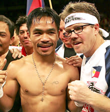 Pacquiao celebrates with his trainer Freddie Roach in 2006 after beating Erik Morales