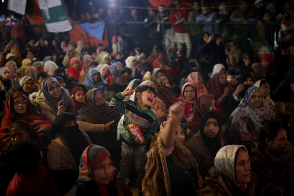 In this Tuesday, Jan. 21, 2020 photo, a young boy shouts slogans inside a tent full of protesters in New Delhi's Shaheen Bagh area, India. Muslim women are transcending the confines of their homes to lay claim to the streets of this nondescript Muslim neighborhood in the Indian capital and slowly transforming it into a nerve center of resistance against a new citizenship law that has unleashed protests across the country. The gathering at Shaheen Bagh started with a handful of women appalled by the violence at a nearby Muslim university during protests against the law on Dec. 15. Since then it has slowly morphed into a nationwide movement, with many women across the country staging their own sit-ins. (AP Photo/Altaf Qadri)