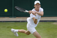 Italy's Jannik Sinner returns to John Isner of the US during their men's singles third round match on day five of the Wimbledon tennis championships in London, Friday, July 1, 2022. (AP Photo/Kirsty Wigglesworth)