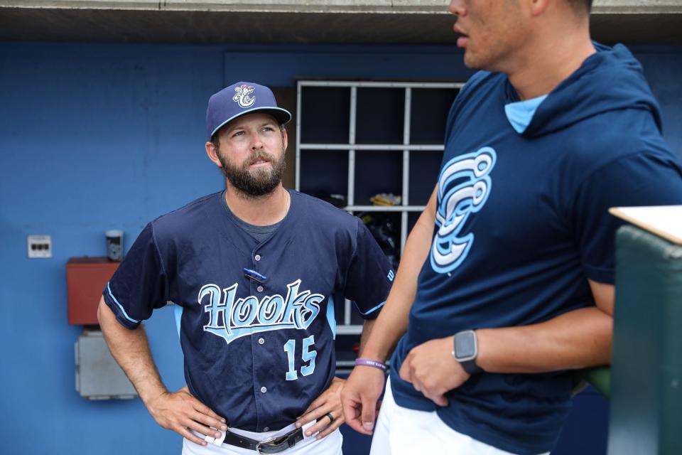 Hooks manager Joe Thon talks to a pitching coach John Kovalik before the exhibition game against Texas A&M-Kingsville at Whataburger Field on April 4, 2023, in Corpus Christi, Texas.
