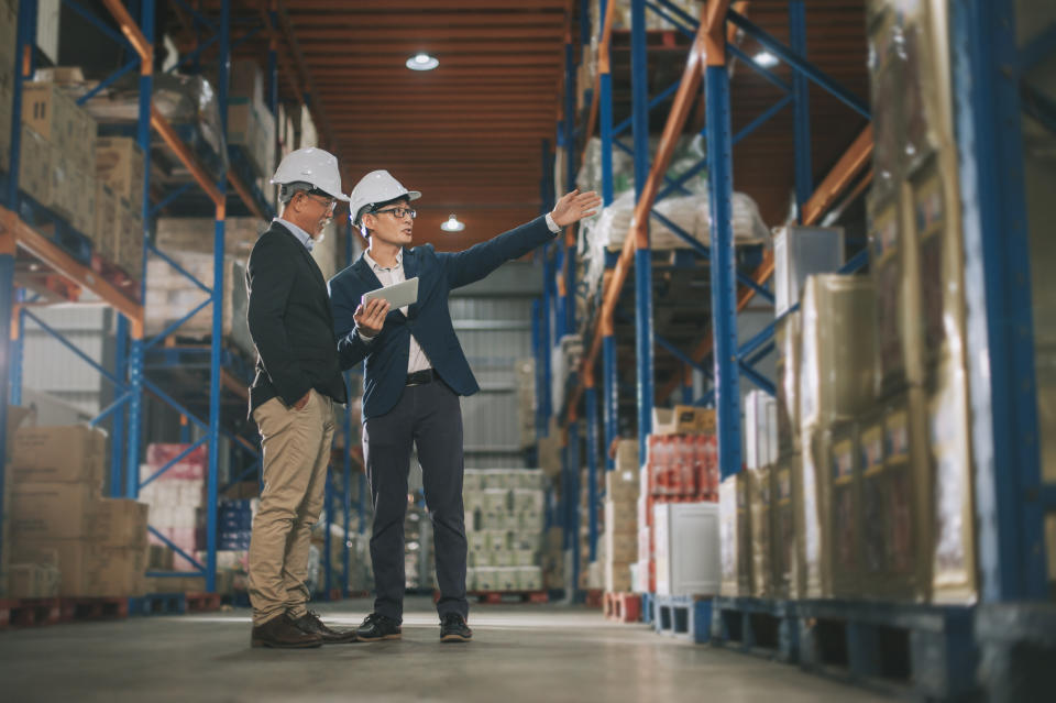 Two men in a warehouse for the SCN Rep Report.