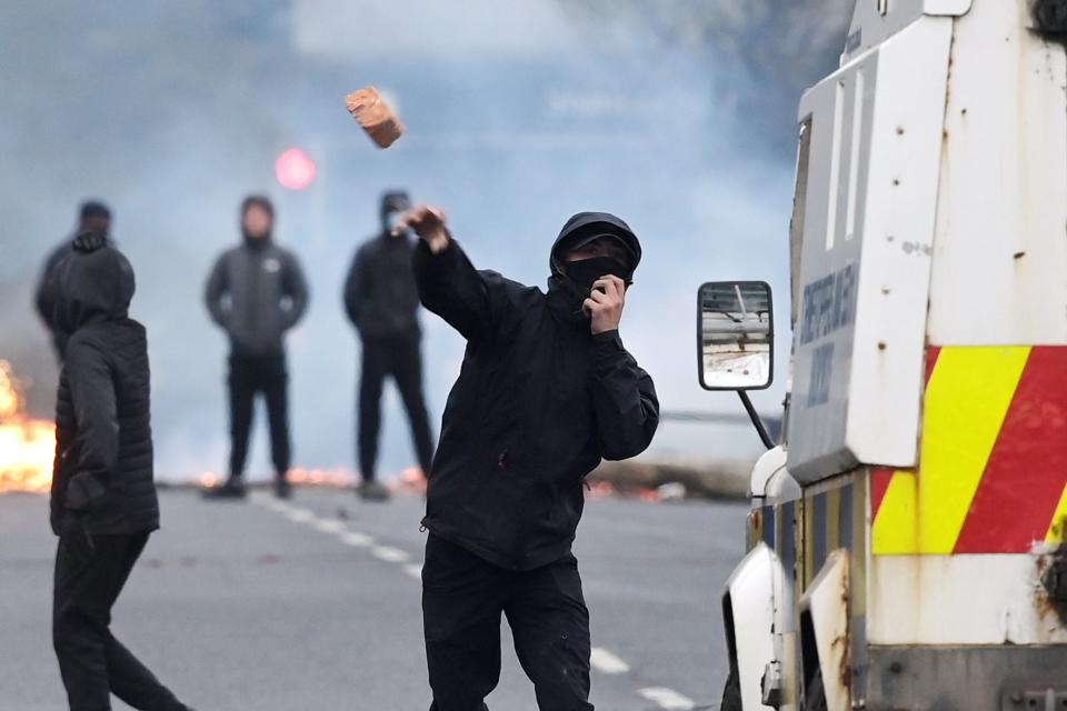 <p>Furniture was set on fire in the road in Belfast this evening</p> (PA)