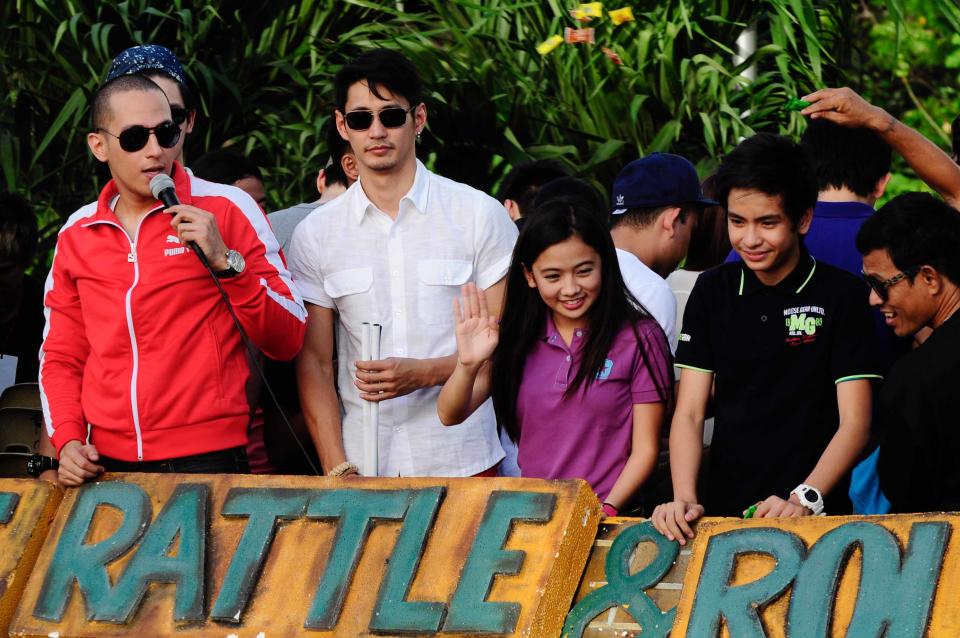 The casts of the MMFF 2012 entry "Shake, Rattle and Roll 14: The Invasion" are seen as their float makes its way through the crowd at the 2012 Metro Manila Film Festival Parade of Stars on 23 December 2012.  (Angela Galia/NPPA Images)