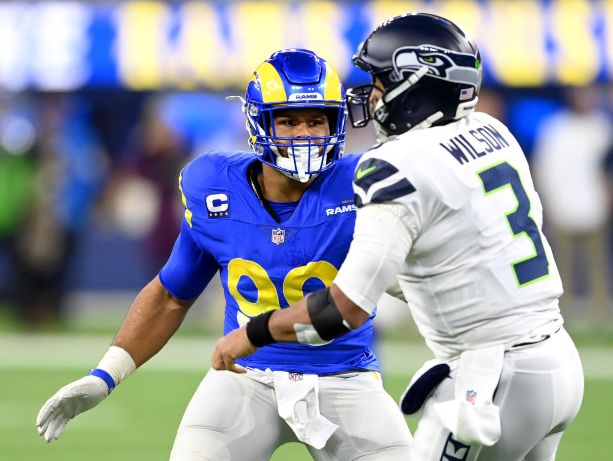 INGLEWOOD, CA - DECEMBER 21:  Aaron Donald #99 of the Los Angeles Rams pressures Russell Wilson #3 of the Seattle Seahawks during the game at SoFi Stadium on December 19, 2021 in Inglewood, California. (Photo by Jayne Kamin-Oncea/Getty Images)
