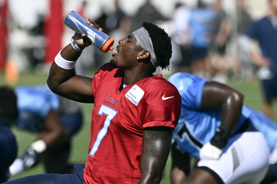 Tennessee Titans quarterback Malik Willis (7) gets a drink during a combined NFL football training camp with the Tampa Bay Buccaneers, Thursday, Aug. 18, 2022, in Nashville, Tenn. (AP Photo/Mark Zaleski)