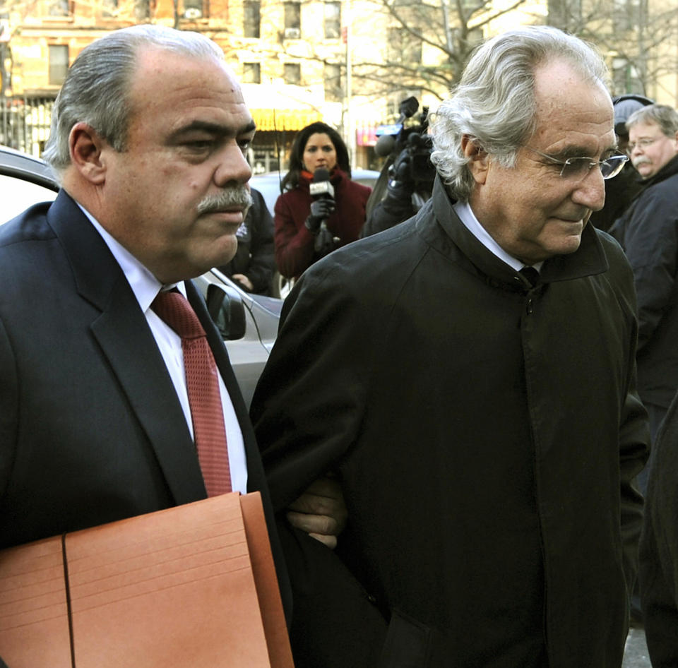 Bernard L. Madoff (R) arrives at US Federal Court for hearing regarding his bail January 14, 2009 in New York. Prosecutors are seeking a reversal of another judge's ruling on Monday that Madoff should be allowed to remain free under house arrest in his luxury Manhattan apartment. Prosecutors say Madoff violated his bail conditions by attempting to distribute more than a million dollars worth of jewelry to friends and relatives, when all his assets are under a court-ordered freeze. AFP PHOTO / TIMOTHY A. CLARY (Photo credit should read TIMOTHY A. CLARY/AFP via Getty Images)