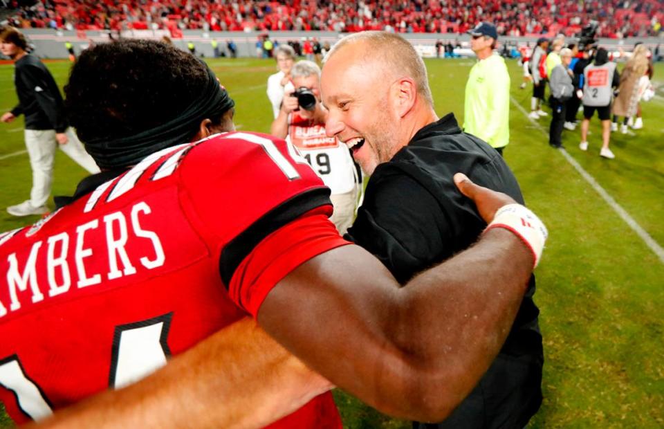 N.C. State head coach Dave Doeren celebrates with quarterback Jack Chambers (14) after N.C. State’s 19-17 victory over Florida State at Carter-Finley Stadium in Raleigh, N.C., Saturday, Oct. 8, 2022.