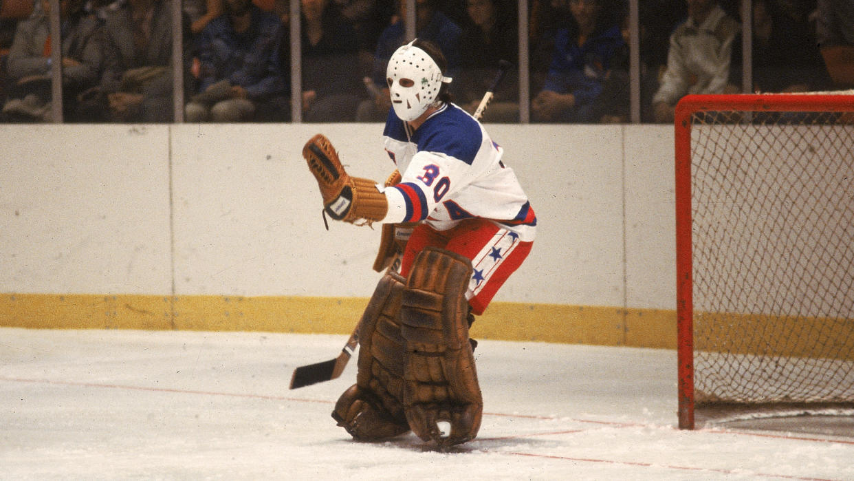 American hockey player Jim Craig, goalkeeper for Team USA, stick out his glove to make a save in an exhibition game against the Soviet team at Madison Square Garden, New York, New York, February 1980.