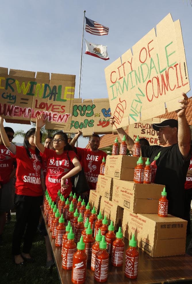 Sriracha hot sauce supporters protest ahead of the city council meeting in Irwindale, Calif., Wednesday, April 23, 2014. The Irwindale City Council has declared that the factory that produces the popular Sriracha hot sauce is a public nuisance. (AP Photo/Damian Dovarganes)