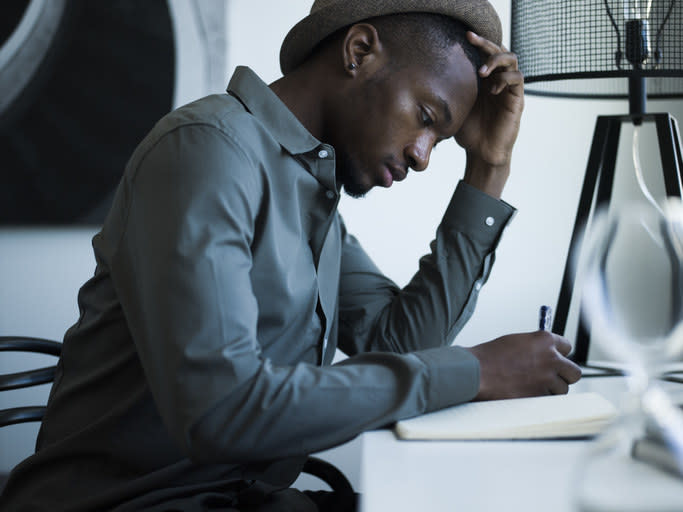 Someone looks stressed while sitting at a desk