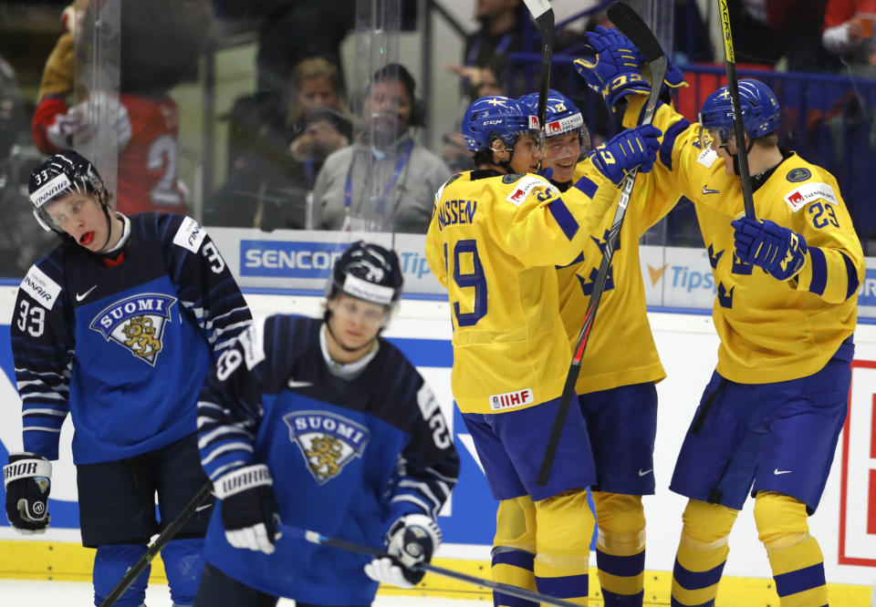 Sweden's Linus Oberg, 2nd right, celebrates with teammates after scoring his sides third goal during the U20 Ice Hockey Worlds bronze medal match between Finland and Sweden in Ostrava, Czech Republic, Sunday, Jan. 5, 2020. (AP Photo/Petr David Josek)