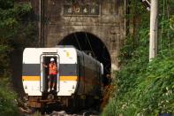 Rescuers work at the site a day after a deadly train derailment at a tunnel north of Hualien