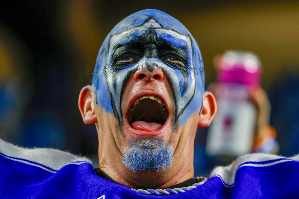 A Detroit Lions fan cheers from the stands during the third quarter of the wild-card round of the NFC playoffs against the L.A. Rams at Ford Field in Detroit on Sunday, January 14, 2023.