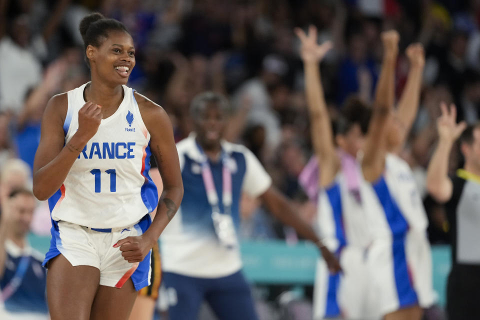 Valeriane Ayayi (11), of France, celebrates after scoring against Belgium during a women's semifinal basketball game at Bercy Arena at the 2024 Summer Olympics, Friday, Aug. 9, 2024, in Paris, France. (AP Photo/Mark J. Terrill)