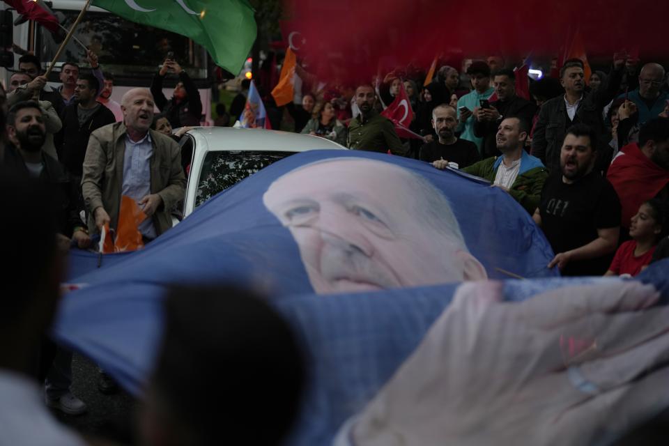 Supporters of the President Recep Tayyip Erdogan celebrate outside AK Party offices in Istanbul, Turkey, Sunday, May 28, 2023. Turkey's incumbent President Recep Tayyip Erdogan has declared victory in his country's runoff election, extending his rule into a third decade. (AP Photo/Khalil Hamra)
