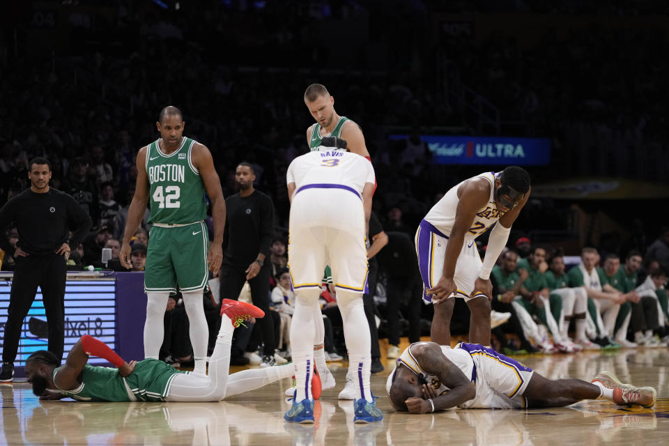 Los Angeles Lakers forward LeBron James, right, and Boston Celtics guard Jaylen Brown, left, react after colliding during the first half of an NBA basketball game, Monday, Dec. 25, 2023, in Los Angeles. (AP Photo/Ryan Sun)