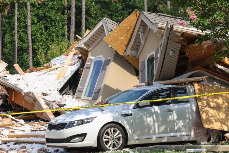 A vehicle is seen under rubble of a home on Lake Norman that collapsed in Mooresville.